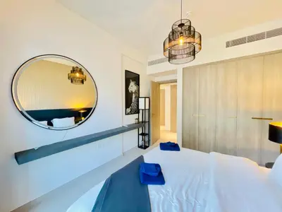 a bedroom with a large mirror and a bed at Luxury 1 Bedroom Apartment in Dubai