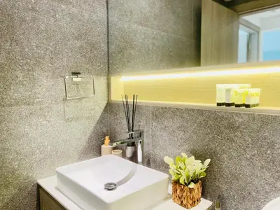 a bathroom with a white sink and a mirror at Brand New Luxury 1 Bedroom Apartment in Dubai