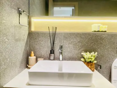 a bathroom with a white sink and a mirror at Brand New Luxury 1 Bedroom Apartment in Dubai