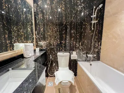 a bathroom with a toilet and a bath tub at Unforgettable 1BR Mesmerizing Burj Khalifa Views - 17AB02 in Dubai