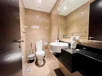a bathroom with a white toilet and a sink at Unforgettable 1BR Mesmerizing Burj Khalifa Views - 17AB02 in Dubai