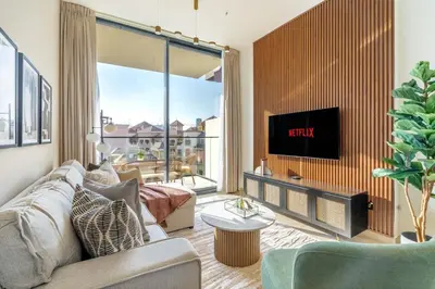 a living room with a couch and a tv at GuestReady - A beautiful home in Jumeirah Village in Dubai