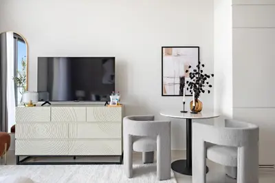 a dining room with a table and chairs and a dresser at Silkhaus New Modern studio - Business Bay - O in Dubai