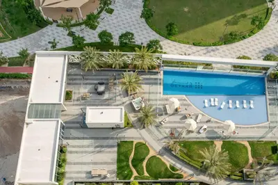 an overhead view of a swimming pool with palm trees at GuestReady - Bella Rose residence in Dubai in Dubai