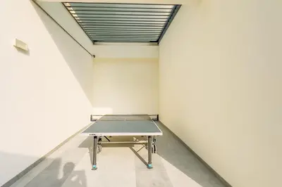 a ping pong table in a room with a ceiling at GuestReady - Bella Rose residence in Dubai in Dubai