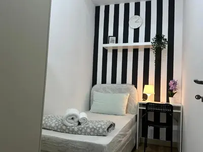 a small room with a chair with towels on it at Lovely Private Partition Room in Barsha Heights in Dubai