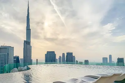 a swimming pool on the roof of a skyscraper with a view of the sh at Frank Porter - Paramount in Dubai