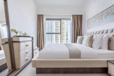 a bedroom with a large bed with a window at Frank Porter - Burj Royale in Dubai