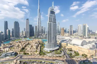 an aerial view of a city with a tall skyscraper at Frank Porter - Burj Royale in Dubai