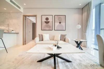 a living room with a couch and a table at Burj Khalifa Views! Promo on 1BR at Sterling House by Deluxe Holiday Homes in Dubai