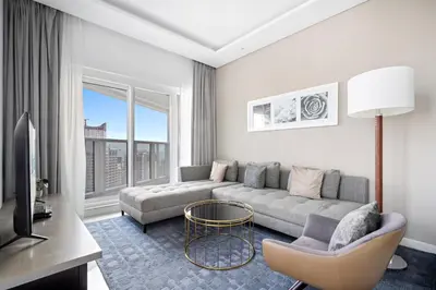 a living room with a couch and a table at ALiving Charming 1BR I Canal Views I DAMAC Maison Prive B- 2101 in Dubai