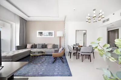 a living room with a couch and a table at ALiving Charming 1BR I Canal Views I DAMAC Maison Prive B- 2101 in Dubai