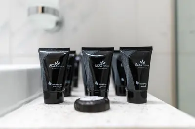 a row of four black toothbrushes on a counter at Modern 1-bedroom apartment in family-friendly residence with Swimming Pool, Gym & Free Parking. in Dubai