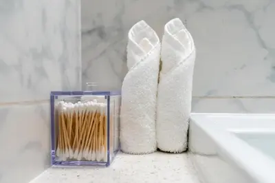 a pair of white boots sitting next to a bathroom tub at Modern 1-bedroom apartment in family-friendly residence with Swimming Pool, Gym & Free Parking. in Dubai