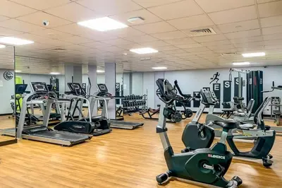 a gym with several treadmills and exercise bikes at Luxury Escapes - Budget 1BR Apt in Marina - Near Tram & Metro -Time Place Tower in Dubai
