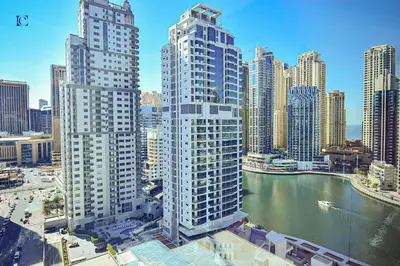 a view of a city with tall buildings and a river at Luxury Escapes - Budget 1BR Apt in Marina - Near Tram & Metro -Time Place Tower in Dubai