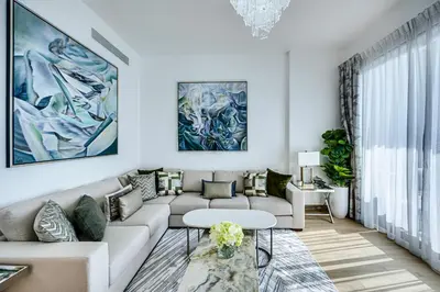 a living room with a couch and a table at Sea View 3 BD apartment in La Mer near the beach in Dubai