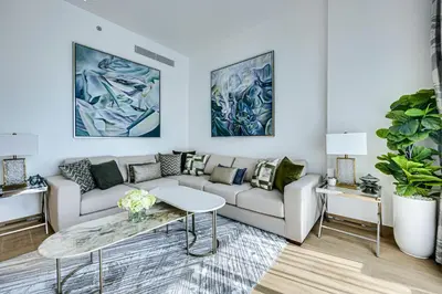 a living room with a couch and a table at Sea View 3 BD apartment in La Mer near the beach in Dubai