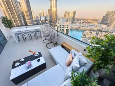 a balcony with a couch and a view of a city at Unique Burj Khalifa View 3BR Condo On Top Floor in Dubai