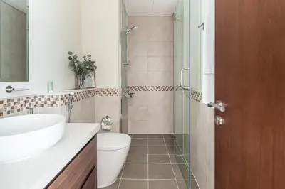 a bathroom with a toilet and a sink and a shower at Frank Porter - Reva Residence in Dubai