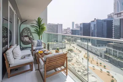 a balcony with chairs and a view of a city at Frank Porter - Reva Residence in Dubai