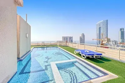 a swimming pool on the roof of a building at Marina View Manchester tower in Dubai