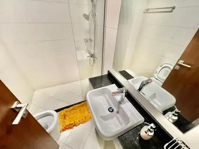 a bathroom with two sinks and a shower at 1o mins to metro. New. Stylish in Dubai
