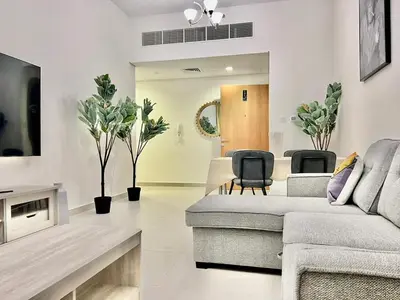 a living room with a couch and chairs at 1o mins to metro. New. Stylish in Dubai