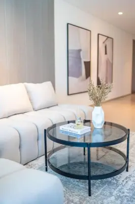 a living room with a white couch and a glass table at The Legend Fashionable 2 Bed Apartment in Downtown in Dubai