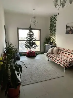 a living room with a christmas tree and a couch at Burj Khalifa view/ Cozy apartment in Dubai