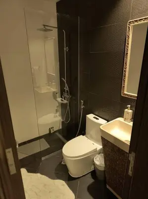 a bathroom with a toilet and a sink and a shower at Burj Khalifa view/ Cozy apartment in Dubai