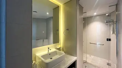 a bathroom with a sink and a mirror at Keyrock Living - Studio with Burj Khalifa View in Dubai