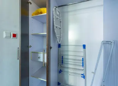 a glass refrigerator in a kitchen with shelves at Unforgettable Canal & Sea View in Dubai Marina in Dubai