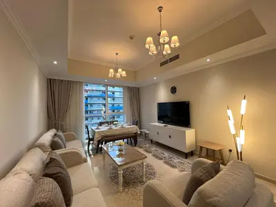 a living room with a couch and a tv and a table at 3 Minutes to Dubai Mall! DVR Vacation Homes in Dubai