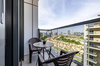 a balcony with a table and chairs and a view at V2 tower Sports city I Studio in Dubai