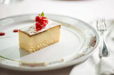 a piece of cake on a plate on a table at Armada Avenue Hotel in Dubai