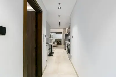 an open door to a kitchen with a hallway at Unique Studio in JVC - Dubai in Dubai