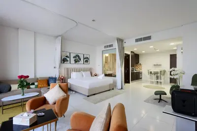 a bedroom with a bed and a living room at Livbnb Seaside Studio in Palm Jumeirah with Private Terrace and Direct Access to Nakheel Mall in Dubai