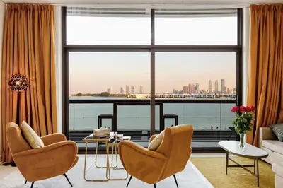 a living room with a view of the city at Livbnb Seaside Studio in Palm Jumeirah with Private Terrace and Direct Access to Nakheel Mall in Dubai