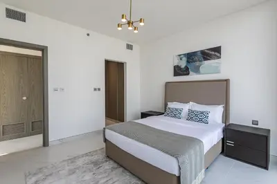 a bedroom with a large bed and a closet at Spacious I Burj Khalifa View I District One in Dubai