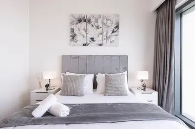a bedroom with a large bed with two night stands at Downtown Luxurious 1BR Near Dubai Mall and Fountain in Dubai