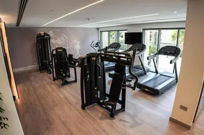 a gym with several tread machines in a room at Downtown Luxurious 1BR Near Dubai Mall and Fountain in Dubai