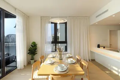 a dining room with a table and a large window at HiGuests - Family Dream Escape with Private Beach Access in Dubai