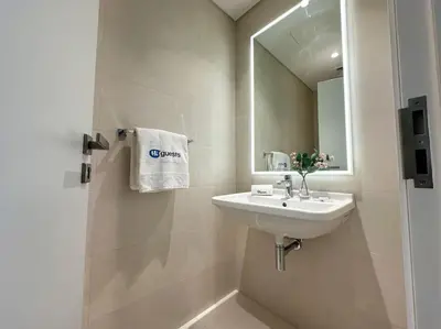 a white bathroom with a sink and a mirror at HiGuests - Family Dream Escape with Private Beach Access in Dubai