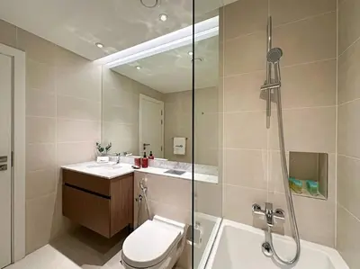 a bathroom with a shower and a toilet and a sink at HiGuests - Dream Vacation Apartment in La Rive 1 in Dubai