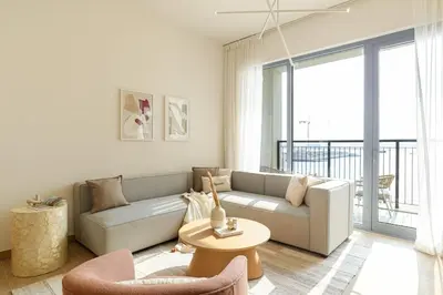 a living room with a couch and a table at HiGuests - Dream Vacation Apartment in La Rive 1 in Dubai