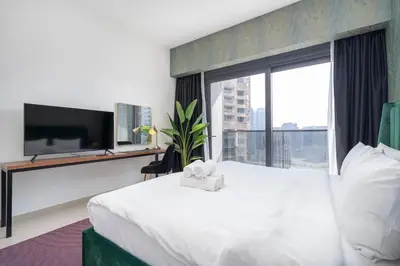 a hotel room with a large bed and a large window at Chic Lux 2BR I High Floor l by Burj Khalifa & Dubai Mall I Pool l Gym in Dubai