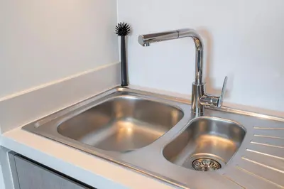 a stainless steel sink in a kitchen with a brush at Chic Lux 2BR I High Floor l by Burj Khalifa & Dubai Mall I Pool l Gym in Dubai