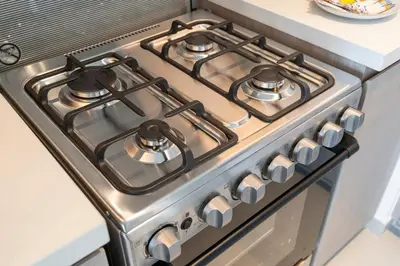 a stainless steel stove top oven in a kitchen at Chic Lux 2BR I High Floor l by Burj Khalifa & Dubai Mall I Pool l Gym in Dubai