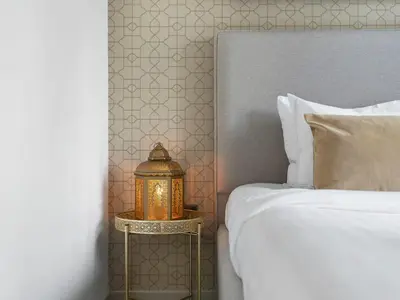 a bedroom with a bed and a lantern on a side table at Luxurious & Spacious 2BR l Burj & Fountain Views l Walk to Dubai Mall l Pool l Gym in Dubai
